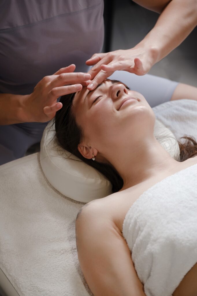 face and head massage at spa Mid adult woman enjoying in her relaxing massage